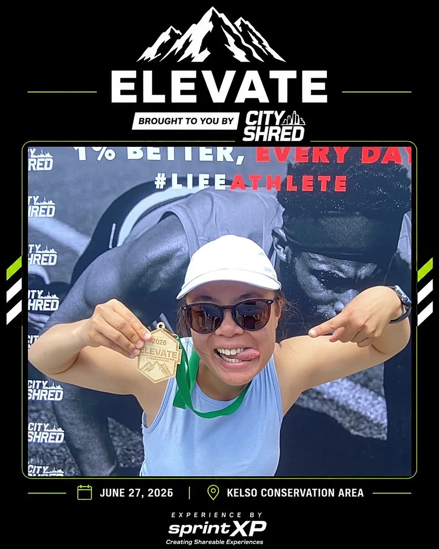 Runner holding a medal inside a branded photo frame