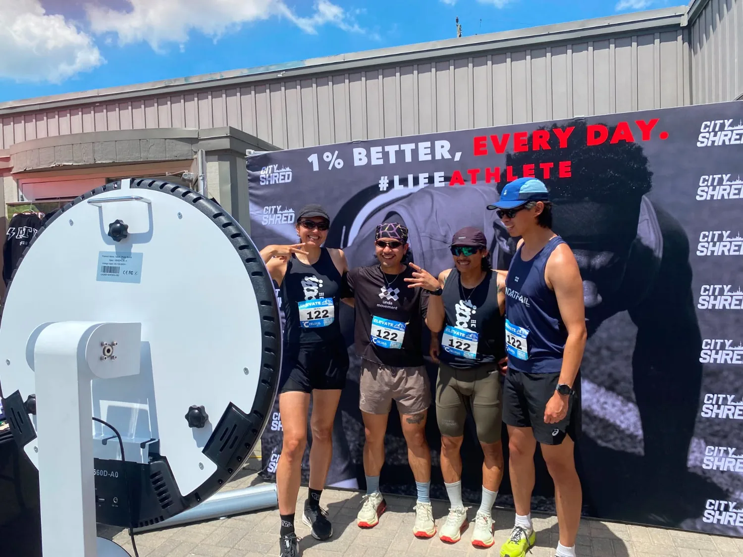 Run club participants posing beside the SprintXP booth